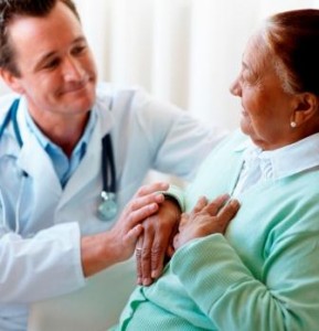 Senior woman being visited by a doctor by her bedside