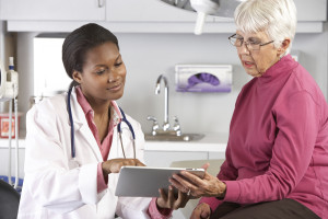 Doctor Discussing Records With Senior Female Patient