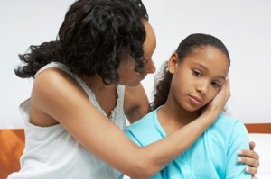 Mother embracing daughter (7-9) in hospital