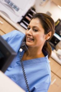 Nurse On The Telephone At Reception Area