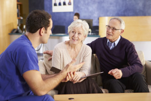 Senior Couple Meeting With Nurse In Hospital